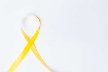 yellow ribbon, symbol against suicide prevention, symbol of hope, amber alert and parenting isolated on white background with space for textの写真素材