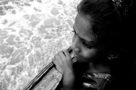 Pangkor Island, Malaysia, March 13, 2011: An Indian girl looking into the horizon from the express boat upon docking at Lumut Jetty in Black & Whiteのeditorial素材