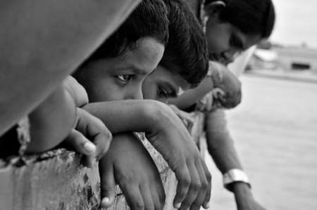 Pangkor Island, Malaysia, March 13, 2011: An Indian boy looking into the horizon from the express boat upon docking at Lumut Jetty in Black & Whiteのeditorial素材