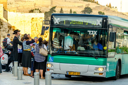 Jerusalem/Israel- August 17, 2016: Group of orthodox Jews waiting to get on a public transit bus at...
