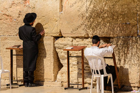 Jerusalem, Israel- July 11, 2014: Two orthodox Jewish men praying at the Western Wall in Jerusalem,...