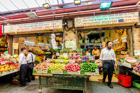 Jerusalem, Israel- August 16, 2016: A crowd of men shopping for vegetables in a shop in the Mahane Yehudah market in Jerusalem, Israelのeditorial素材