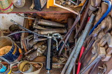 Swift Current, SK/Canada- May 1, 2020: A collection of vintage grease guns, pipe wrenches and various hardwareのeditorial素材