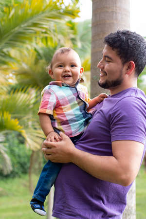 father holding his son in his arms, latin nature conceptの写真素材