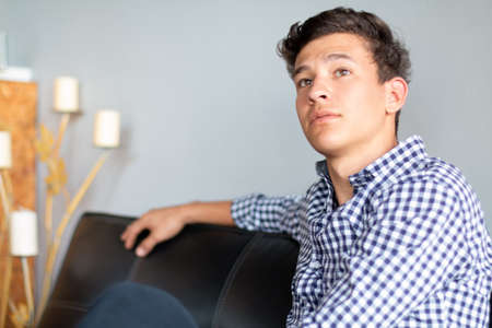 Young, handsome businessman sitting waiting for something.の写真素材