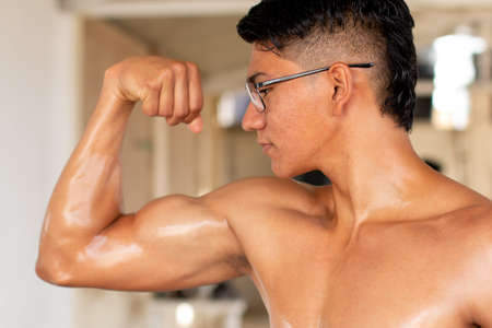 Latin man flexing his muscular arm.の写真素材
