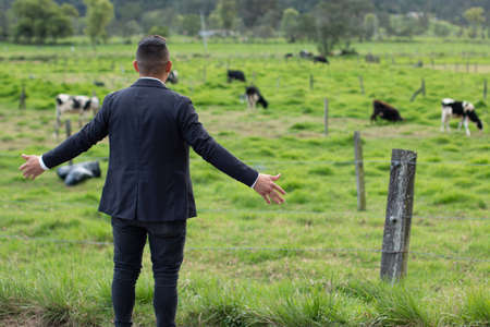 Man with his back turned looking at beautiful pasture.の写真素材
