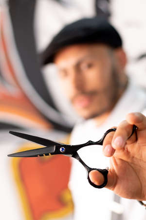 Barber showing his scissors, his working tool. barber shop.の写真素材