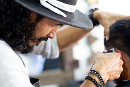 Barber at work. Close-up. Cutting and fixing hair.の写真素材