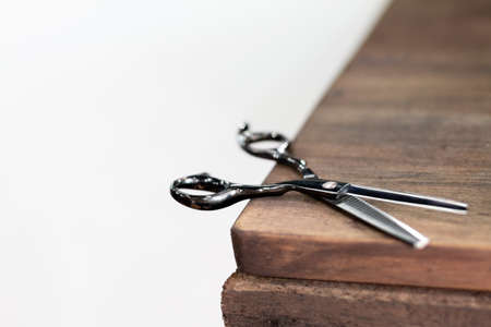 Detail photo of beautiful black scissors on barber wood for thinning out hair. Thinning Shears For Hair Cutting Hair Thinning Scissors Teeth Shears Professional Barber.の写真素材