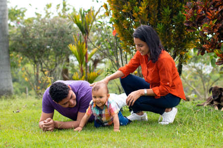 Dad and mom with their son in the field.の写真素材