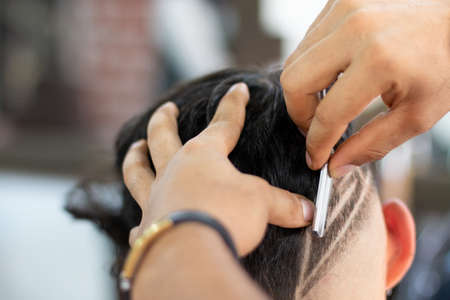 Barber doing Highborn and freestyle by hand. Styling and cut shaving.の写真素材