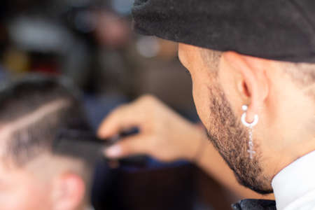 Unknown man combing his clients hair in a barber shop. Hair Stimulation growthの写真素材