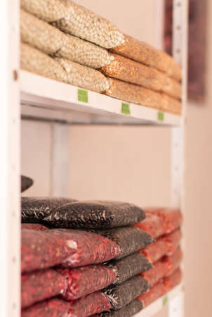Peas, lentils and colored beans. Grain store shelf with transparent bags. Agricultural sector. Grain store.の写真素材
