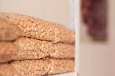 Dried chickpeas stacked in transparent bags. Latin grain store. Natural store.
