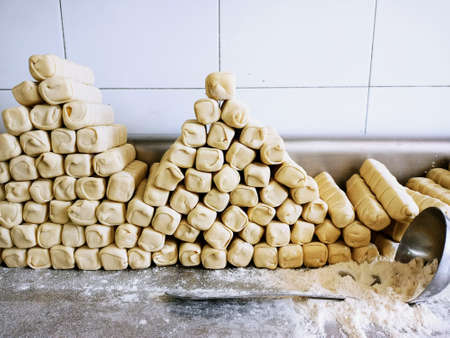 Stack of unbaked cheese sticks. Puff pastry roll or cheese fingers. latin bread. latin recipes. ready to bake bread.の写真素材