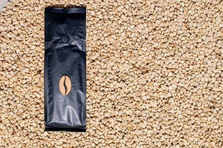 Luxury ambassadorial bag for coffee on a background of coffee beans. Paper bag for coffee beans....