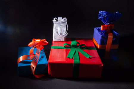 Gifts isolated on black background. Christmas or seasonal gifts ready to deliver. Beautiful...