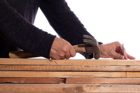 Man using hammer and wooden nail, isolated on white background. Unknown man working with wooden...