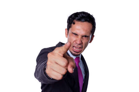 Very angry businessman boss scolding, shouting and pointing at the camera. Concept of an abusive and...