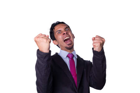 Businessman shouting from joy and raising his fists, Businessman rejoicing for his success isolated on all-white background.の写真素材