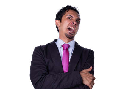 Businessman with a wicked look and a wicked laugh, isolated on an all white background.の写真素材