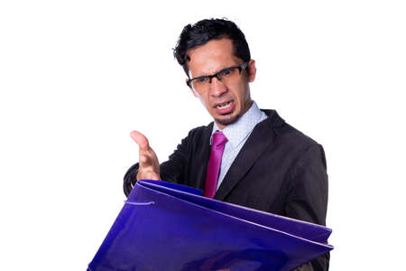 Angry businessman checking and complaining about some documents. Businessman wearing glasses isolated on all white background.の写真素材