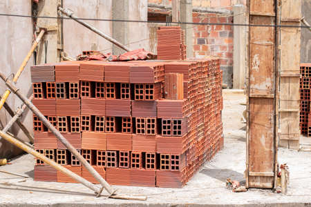 Pile of brick blocks for the construction of a modern house, Second stage of construction of a house.の写真素材