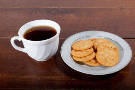Cookies with Colombian drink on a wooden table. Aguadepanela with cookies for appetizer.の写真素材