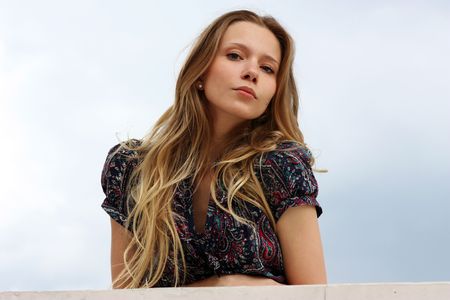 Beautiful woman standing against wall in background の写真素材