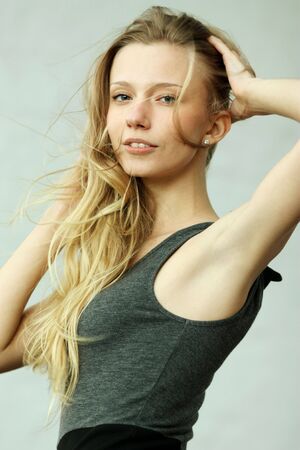 Beautiful woman standing against wall in background の写真素材