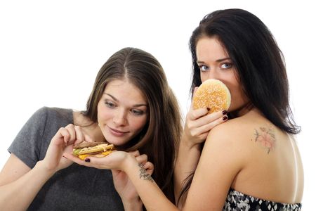 Two girls divide one sandwichの写真素材