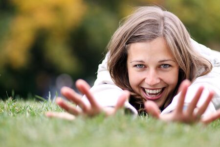 beautiful young woman relaxing in the grass の写真素材