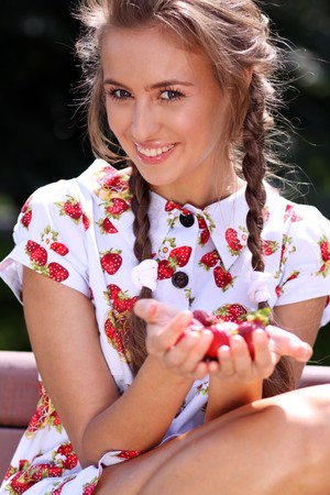 Portrait of the beautiful girl with a strawberryの写真素材