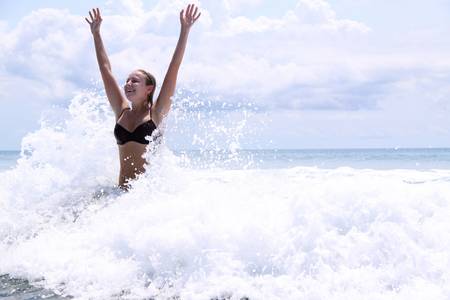 beautiful woman bathes at ocean の写真素材