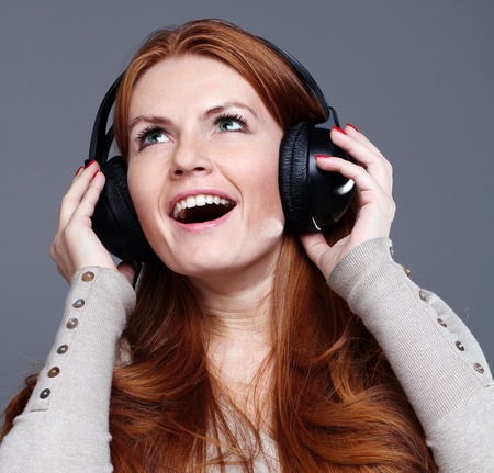 happy young woman listening to music の写真素材