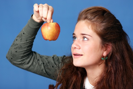 Beautiful young woman in blue backgroundの写真素材