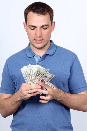 Man with money showing thumbs up の写真素材