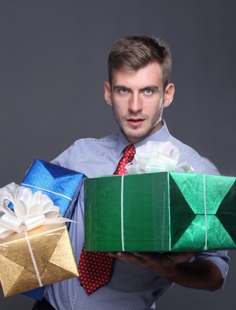 Portrait of young business man with giftsの写真素材