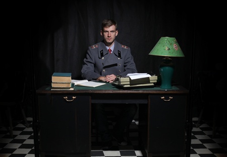 Russian military officer in a dark cabinet