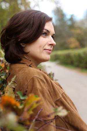 Beautiful young woman in autumn parkの写真素材