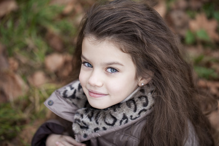 Autumn portrait of a beautiful young girl on the streetの写真素材