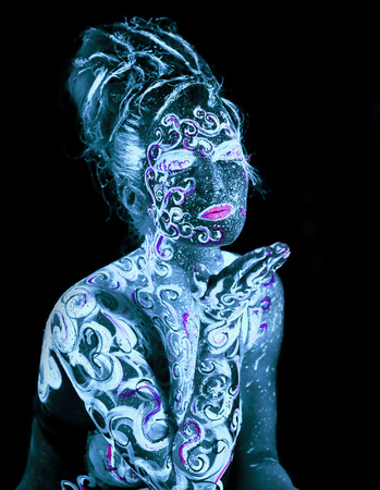 Body art glowing in ultraviolet lightの写真素材
