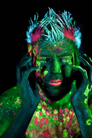 Body art glowing in ultraviolet lightの写真素材