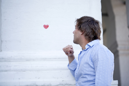 Portrait of love men in love and a symbol of love - red heartの写真素材