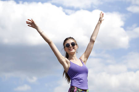Portrait of young woman enjoying life against the blue skyの写真素材