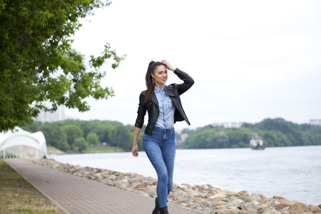 Full length portrait of a young lady walking outdoorの写真素材