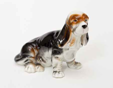 Basset Hound. Ceramic figurine, dog breed isolated on whiteの写真素材