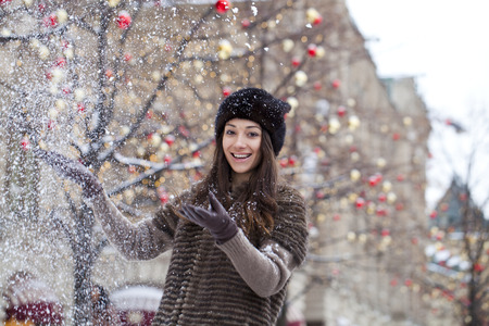 Young beautiful woman in stylish mink coat on a background of a winter streetの写真素材