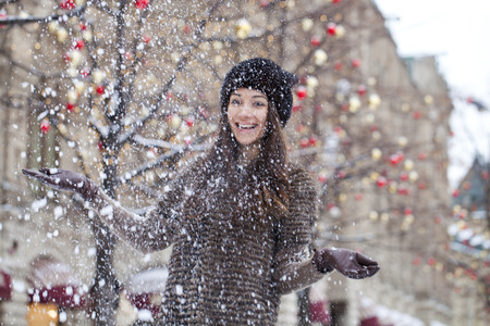 Young beautiful woman in stylish mink coat on a background of a winter streetの写真素材
